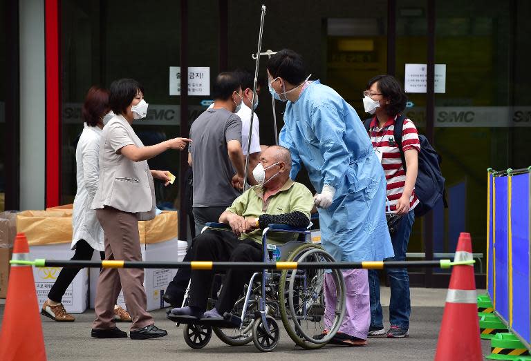 A nurse moves a man (C), suspected of carrying MERS virus, at the Samsung Medical Centre in Seoul, on June 8, 2015