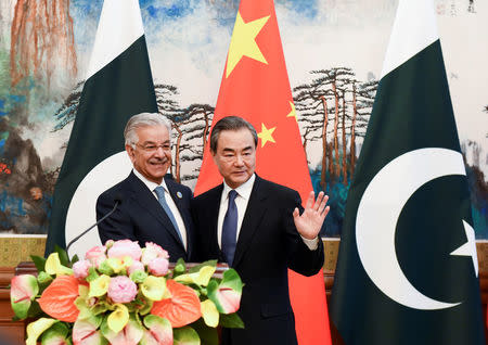 Pakistan’s Foreign Minister Khawaja Muhammad Asif (left) and Chinese State Councilor and Foreign Minister Wang Yi (right) pose after their press conference at the Diaoyutai State Guest House in Beijing, China, April 23, 2018. Madoka Ikegami/Pool via Reuters