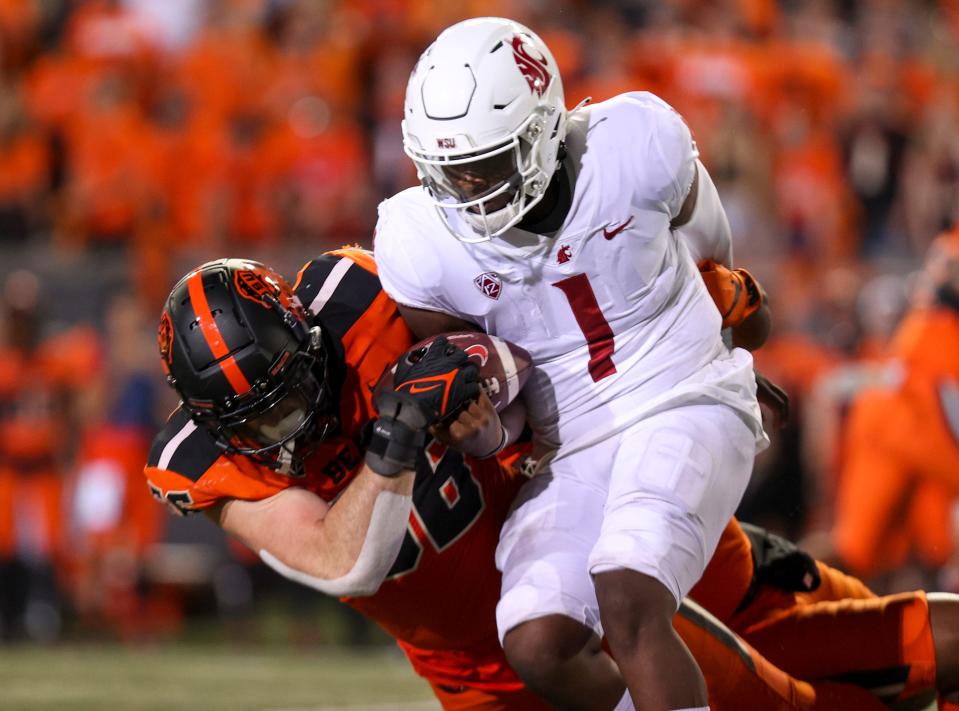 Oregon State Beavers linebacker Riley Sharp strip sacks the ball from Washington State quarterback Cameron Ward (1) during the third quarter at Reser Stadium at Oregon State University in Corvallis on Oct. 15, 2022.