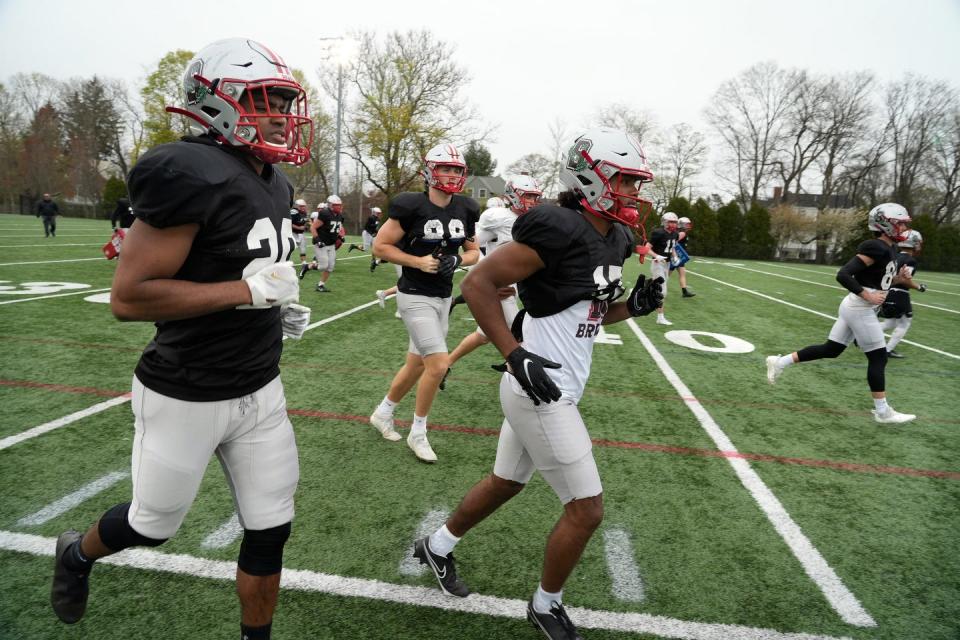 Players go through a drill during Tuesday's spring football practice at Brown.