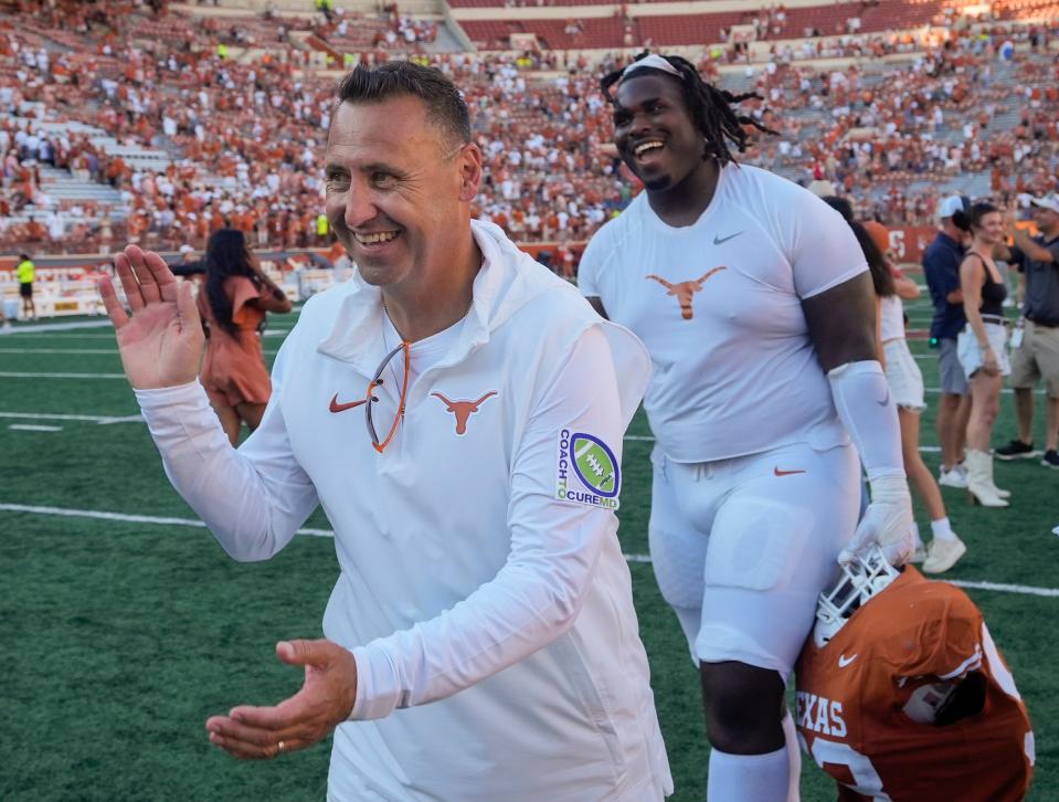 Texas head coach Steve Sarkisian and defensive tackle T'Vondre Sweat smile as they walk off the field at Royal-Memorial Stadium following last Saturday's 40-14 win over Kansas. The Longhorns are 5-0 and No. 3 in the country.