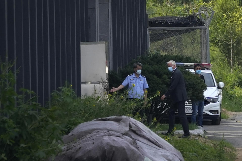 Dominic Barton, third from left, Canada Ambassador to China, walks into a detention center to meet Canadian Michael Spavor, in Dandong, China, Wednesday, Aug. 11, 2021. A Chinese court has sentenced Spavor to 11 years on spying charges in case linked to Huawei. (AP Photo/Ng Han Guan)