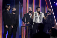 Matthew Ramsey, second from right, and members of Old Dominion, accept the award for group of the year at the 56th annual Academy of Country Music Awards on Sunday, April 18, 2021, at the Grand Ole Opry in Nashville, Tenn. (AP Photo/Mark Humphrey)