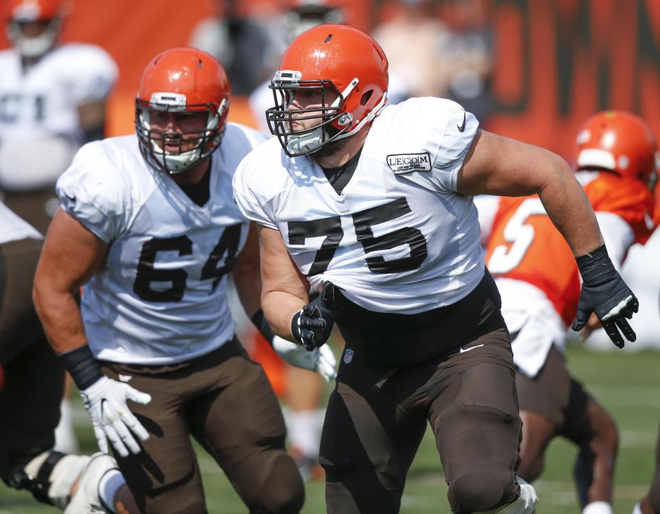 Cleveland Browns offensive tackle Joel Bitonio (75) and center JC Tretter (64) look to make a block during training camp Sunday, Aug. 12, 2018, in Berea.