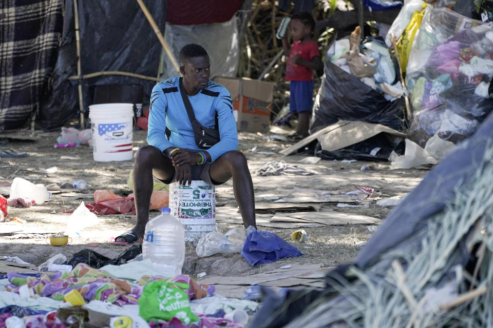 FILE - In this Sept. 23, 2021, file photo, a migrant man is seen in an encampment under the Del Rio International Bridge where migrants, many from Haiti, have been staying after crossing the Rio Grande, in Del Rio, Texas. The Border Patrol's treatment of Haitian migrants, they say, is just the latest in a long history of discriminatory U.S. policies and of indignities faced by Black people, sparking new anger among Haitian Americans, Black immigrant advocates and civil rights leaders. (AP Photo/Julio Cortez)