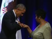 US President Barack Obama fist bumps with singer Aretha Franklin, who he said "helped define the American experience"