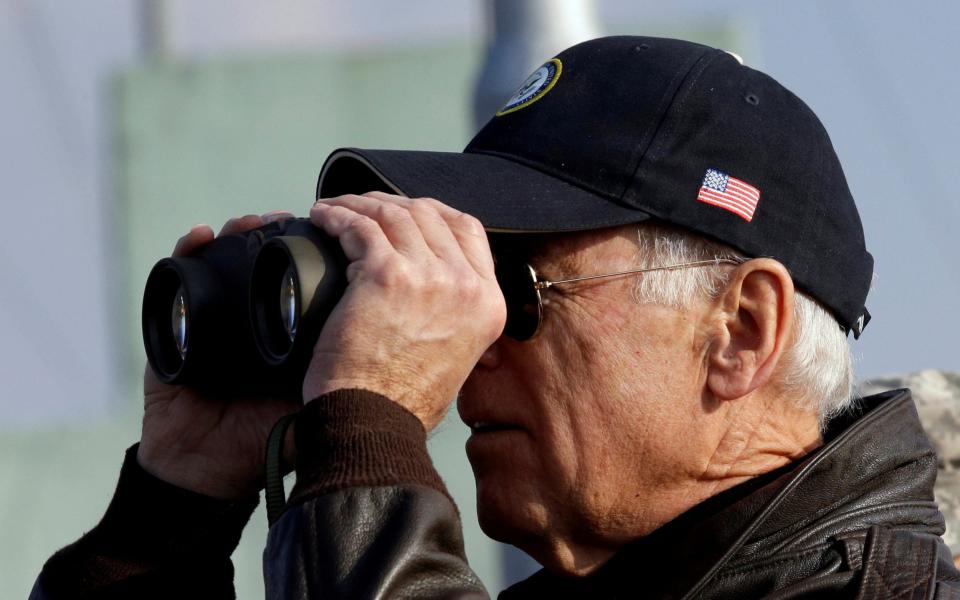 Vice President Joe Biden looks through binoculars to see North Korea from Observation Post Ouellette during a tour of the DMZ in 2013 - Reuters