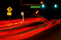 This long exposure photo shows traffic driving on Roosevelt Boulevard at Banks Way, named for Samara Banks and her three children who were struck and killed by a car in 2013, in Philadelphia, Wednesday, May 25, 2022. (AP Photo/Matt Rourke)