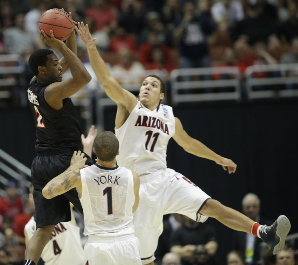 San Diego State guard Xavier Thames (2) looks to pass under pressure from Arizona forward Aaron Gordon (11) and guard Gabe York (1) during the second half of a regional semifinal in the NCAA men's college basketball tournament, Thursday, March 27, 2014, in Anaheim, Calif. (AP Photo/Jae C. Hong)