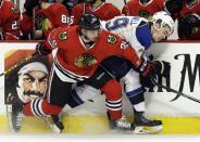St. Louis Blues' Adam Cracknell, right, is checked by Chicago Blackhawks' Brandon Saad during the first period in Game 4 of a first-round NHL hockey playoff series in Chicago, Wednesday, April 23, 2014. (AP Photo/Nam Y. Huh)
