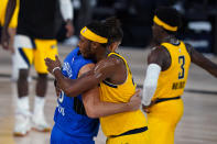 Indiana Pacers center Myles Turner (33) hugs Orlando Magic center Nikola Vucevic (9) following a 120-109 win over the Magic in an NBA basketball game Tuesday, Aug. 4, 2020 in Lake Buena Vista, Fla. (AP Photo/Ashley Landis)