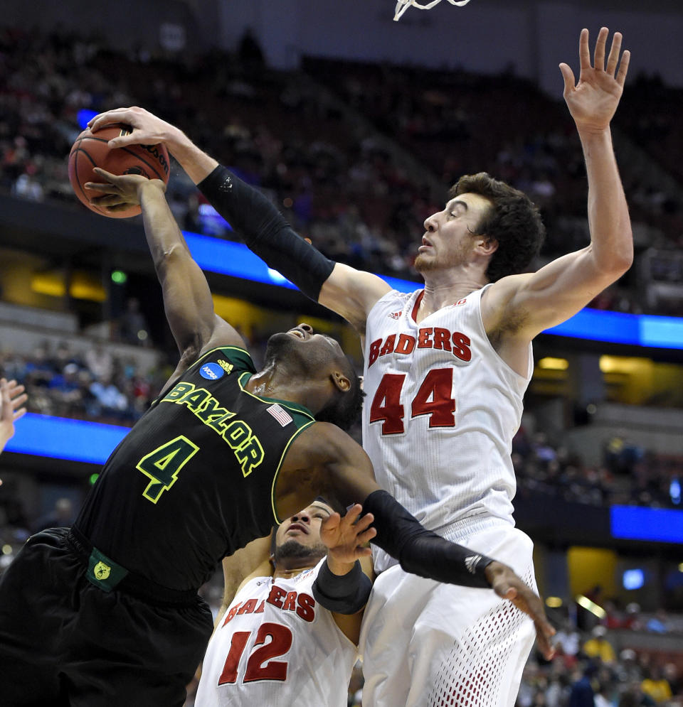 Baylor guard Gary Franklin (4) has a shot stopped by Wisconsin forward Frank Kaminsky (44) during an NCAA men's college basketball tournament regional semifinal, Thursday, March 27, 2014, in Anaheim, Calif. (AP Photo/Mark J. Terrill)