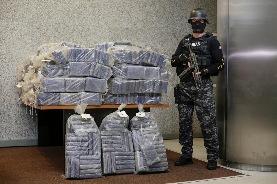 Romanian special forces unit member stands guard near cocaine seized