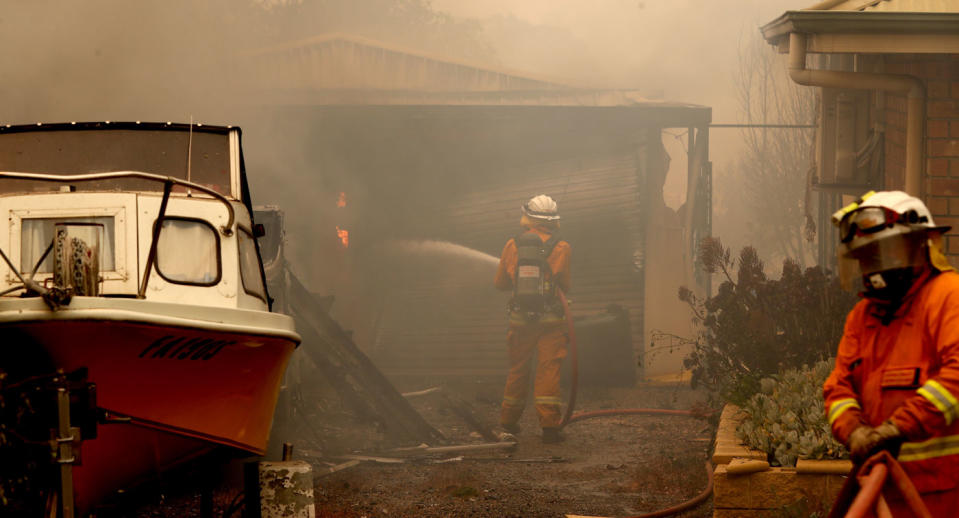 CFS firefighters put out fires on Jacaranda Drive at Woodside in the Adelaide Hills in Adelaide.