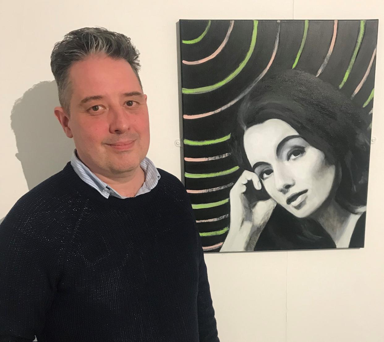 Seymour Platt with a portrait of his mother, Christine Keeler, painted by Fionn Wilson (De Montfort University/PA)