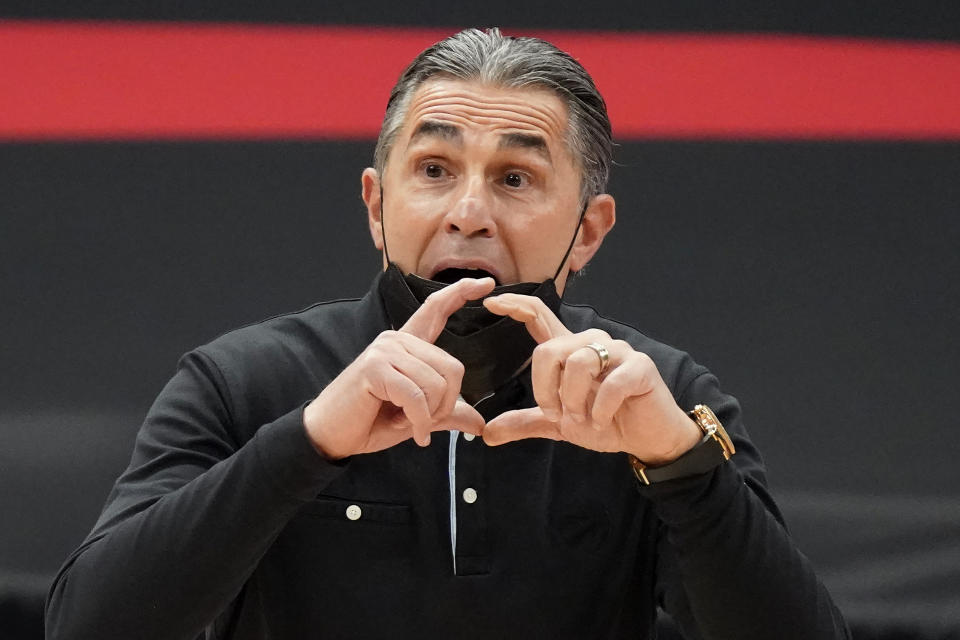 Toronto Raptors assistant coach Sergio Scariolo calls a play during the first half of an NBA basketball game against the Houston Rockets Friday, Feb. 26, 2021, in Tampa, Fla. Scariolo is filling in for head coach Nick Nurse, who is missing the game due to coronavirus protocol. (AP Photo/Chris O'Meara)