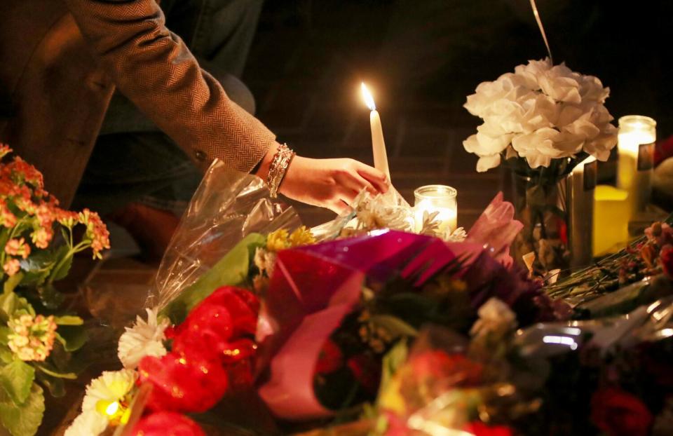 Mourners take part in a vigil for victims of a mass shooting at Star Ballroom Dance Studio in Monterey Park.