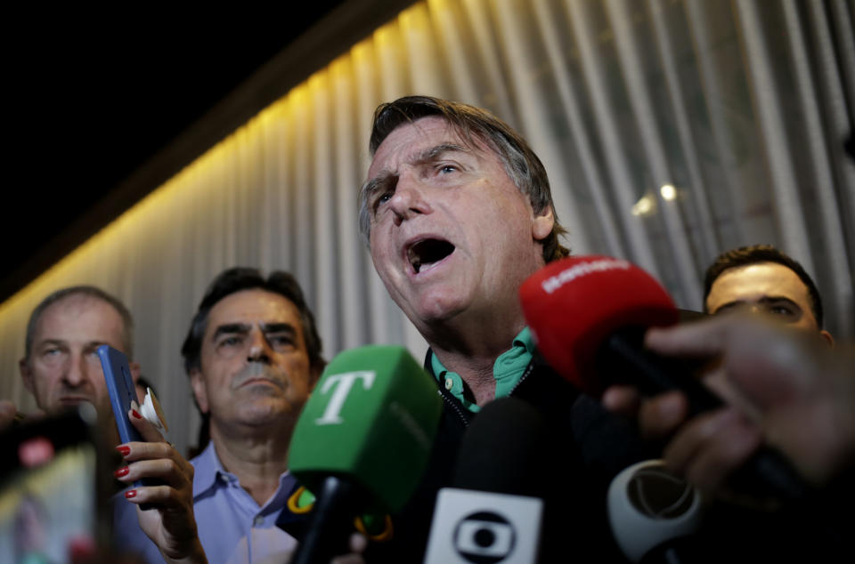Brazil's former President Jair Bolsonaro speaks with the press inside a restaurant in Belo Horizonte, Brazil, Friday, June 30, 2023. The panel of judges voted Friday to render Bolsonaro ineligible to run for office again after concluding that he abused his power and cast unfounded doubts on the country's electronic voting system. (AP Photo/Thomas Santos)