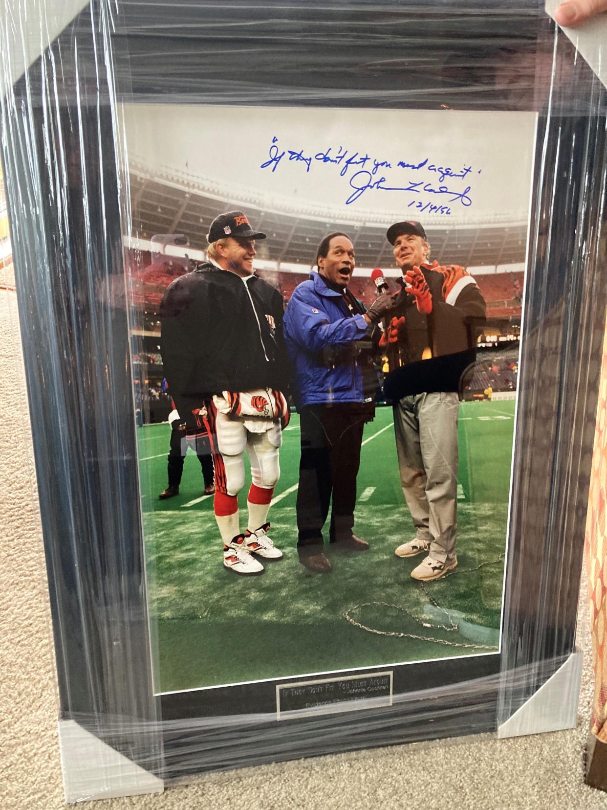 A closeup of the photo Renken took of Simpson wearing gloves while interviewing Bengals head coach Sam Wyche and quarterback Boomer Esiason.