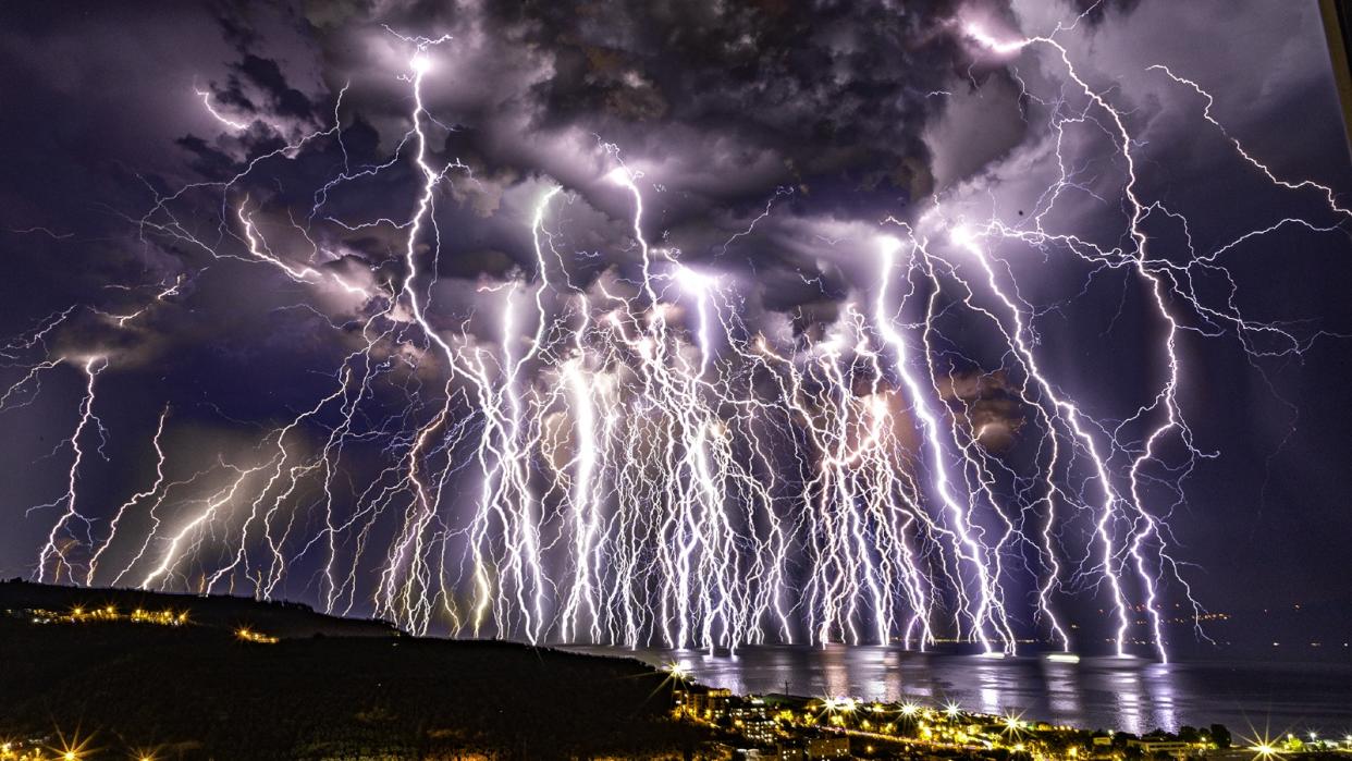  Hundreds of lightning bolts illuminate the night sky during thunderstorm 