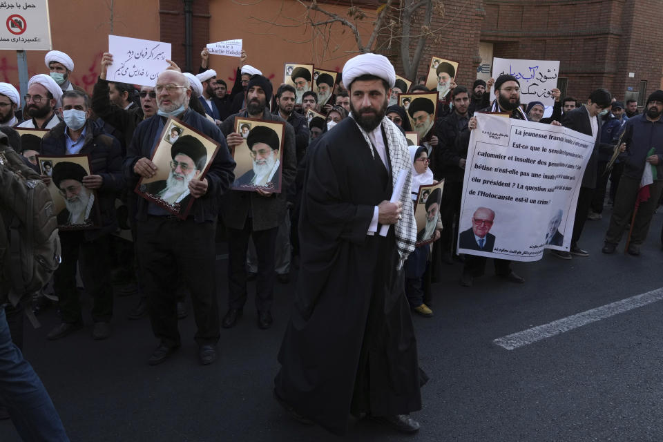 Iranian demonstrators gather to protest against the publication of offensive caricatures of the Iranian Supreme Leader Ayatollah Ali Khamenei in the French satirical magazine Charlie Hebdo, in front of the French Embassy in Tehran, Iran, Sunday, Jan. 8, 2023. (AP Photo/Vahid Salemi)