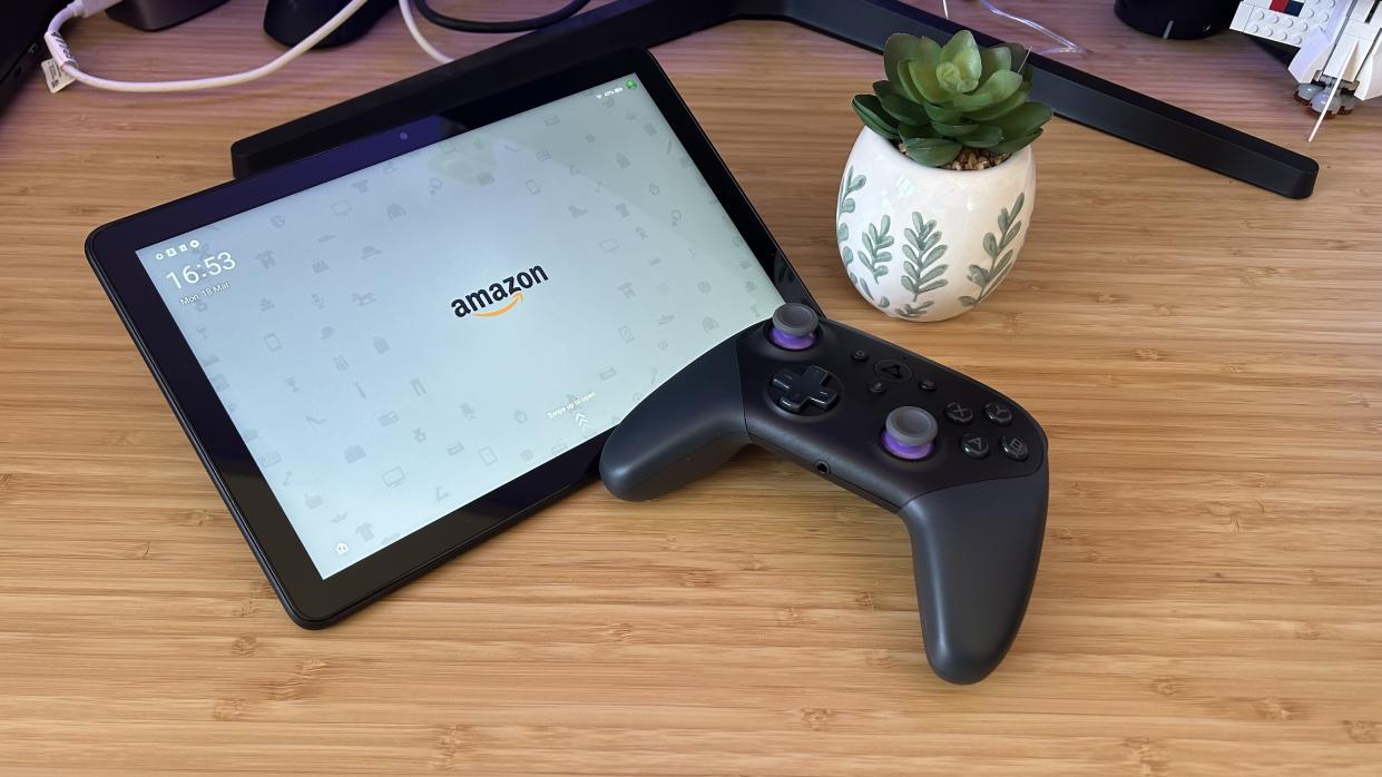  Amazon Fire HD 10 tablet with Luna controller and a plant on a wooden desk. 