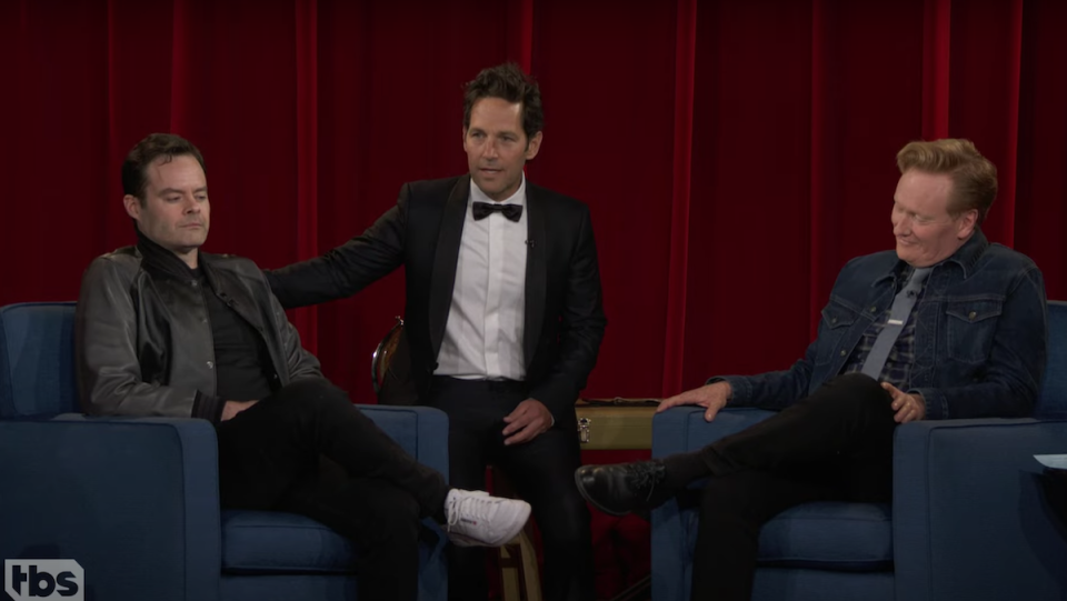 Bill Hader, Paul Rudd (in a tux) and Conan O'Brien sit on the set of Conan.