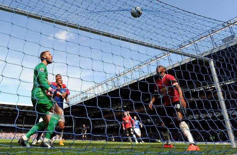 Manchester United's goalkeeper David de Gea (L) reacts after Everton's defender John Stones (unseen) scored a goal during the English Premier League football match Everton vs Manchester United at Goodison park in Liverpool on April 26, 2015