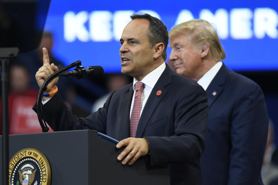 President Donald Trump, right, listens as Kentucky Gov. Matt Bevin, left, speaks during a campaign rally in Lexington, Ky., Monday, Nov. 4, 2019. (AP Photo/Susan Walsh)