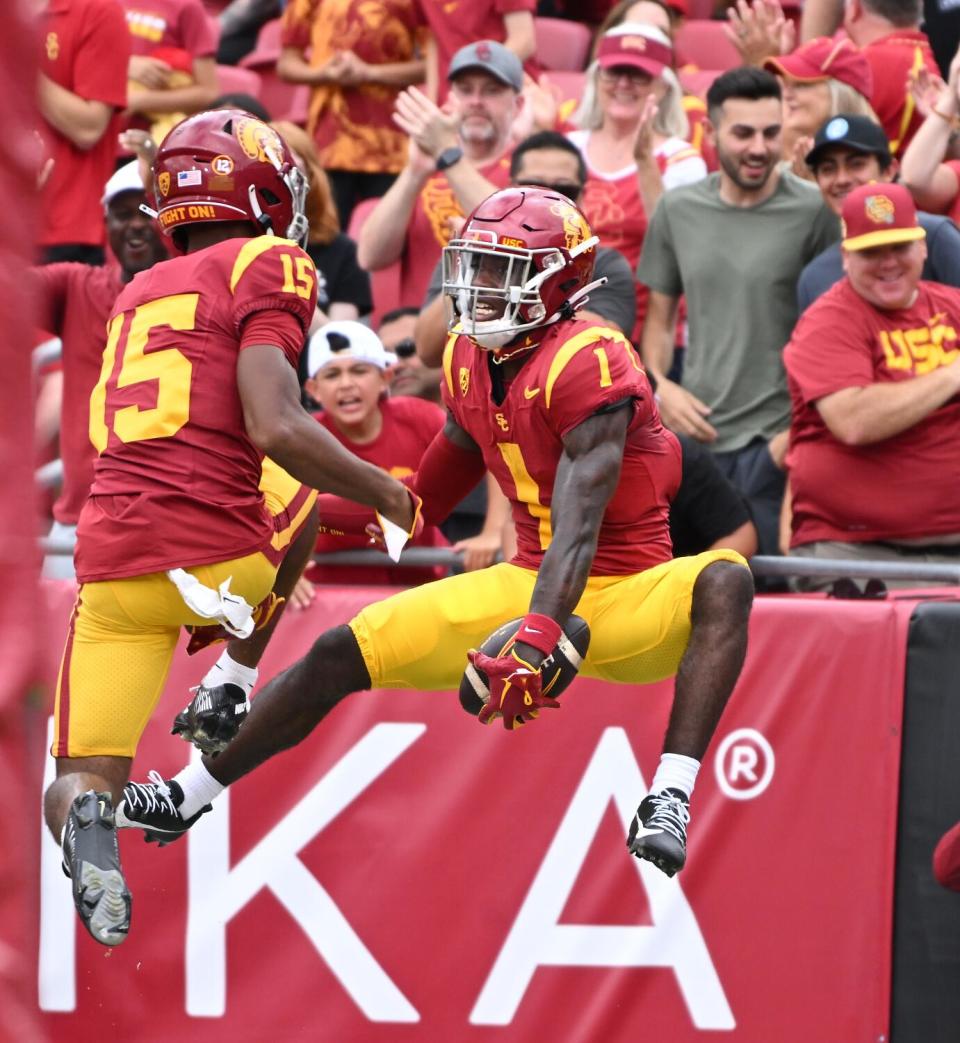 USC receiver Zachariah Branch celebrates his touchdown catch with Dorian Singer.