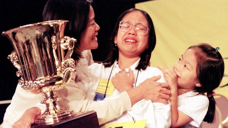 Wendy Guey, 12, was a seventh-grade student at Bak Middle School (formerly Palm Beach Middle School of the Arts), when she won the National Spelling Bee in 1996. Her mother, Susan, and sister, Lynne, 6, hug her after winning the 69th National Spelling Bee in Washington D.C..