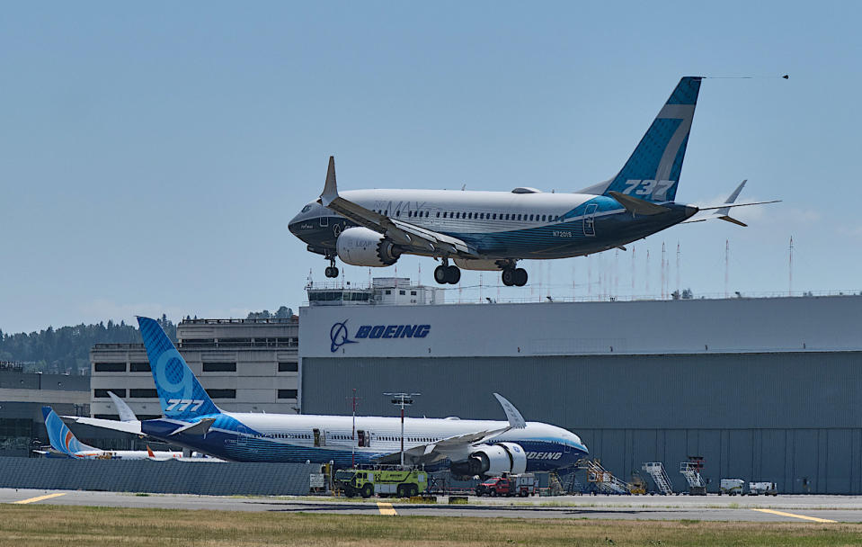 SEATTLE, WA - JUNE 29: A Boeing 737 MAX aircraft lands following a FAA recertification flight at Boeing Field on June 29, 2020 in Seattle, Washington. The 737 MAX has been grounded for commercial flights since March of 2019 following two crashes. In the background is a Boeing 777X test plane. (Photo by Stephen Brashear/Getty Images)