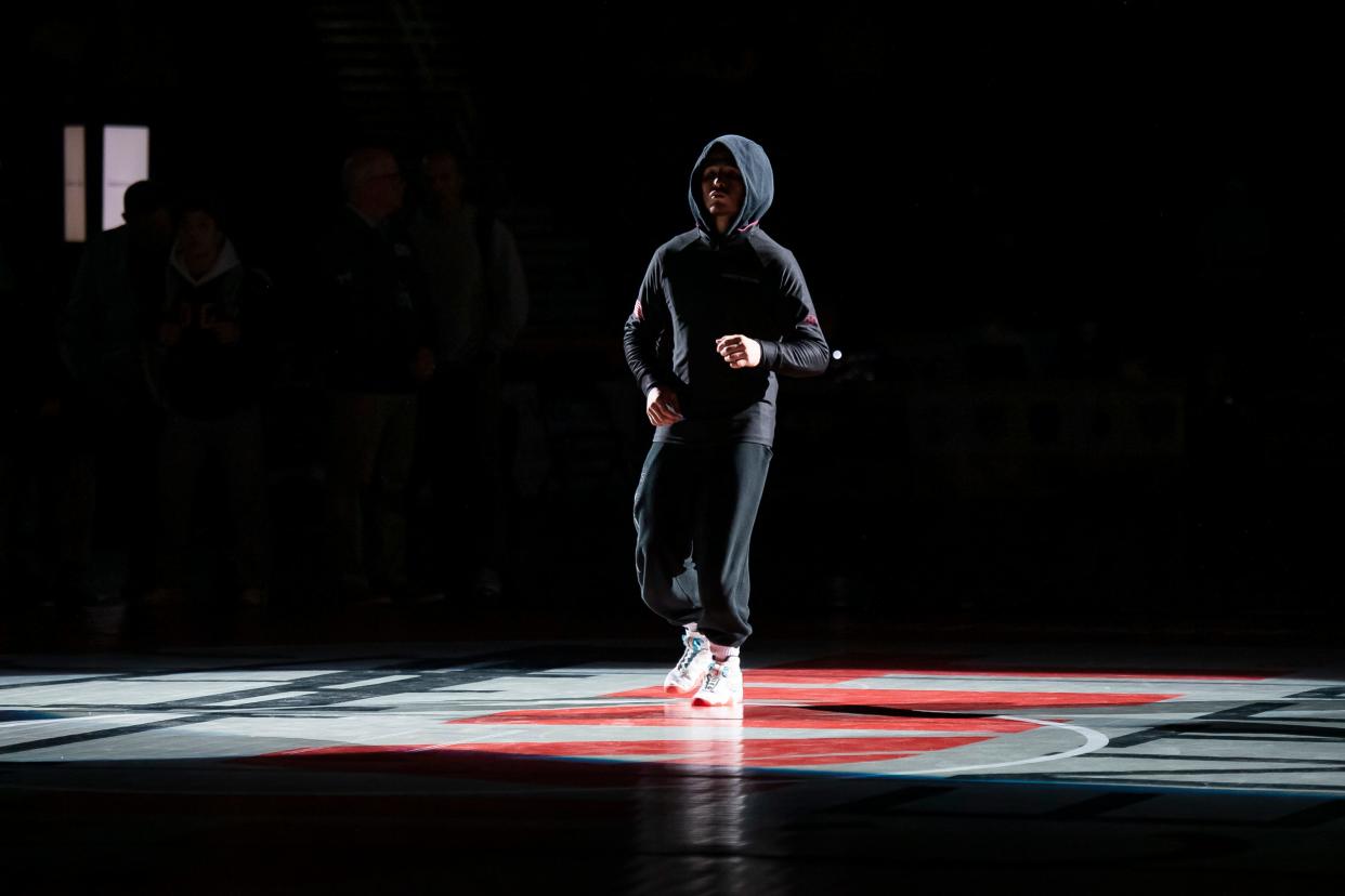 Faith Christian's Gauge Botero is introduced during the parade of champions before his 121-pound championship bout at the PIAA Class 2A Wrestling Championships at the Giant Center on March 11, 2023, in Hershey.