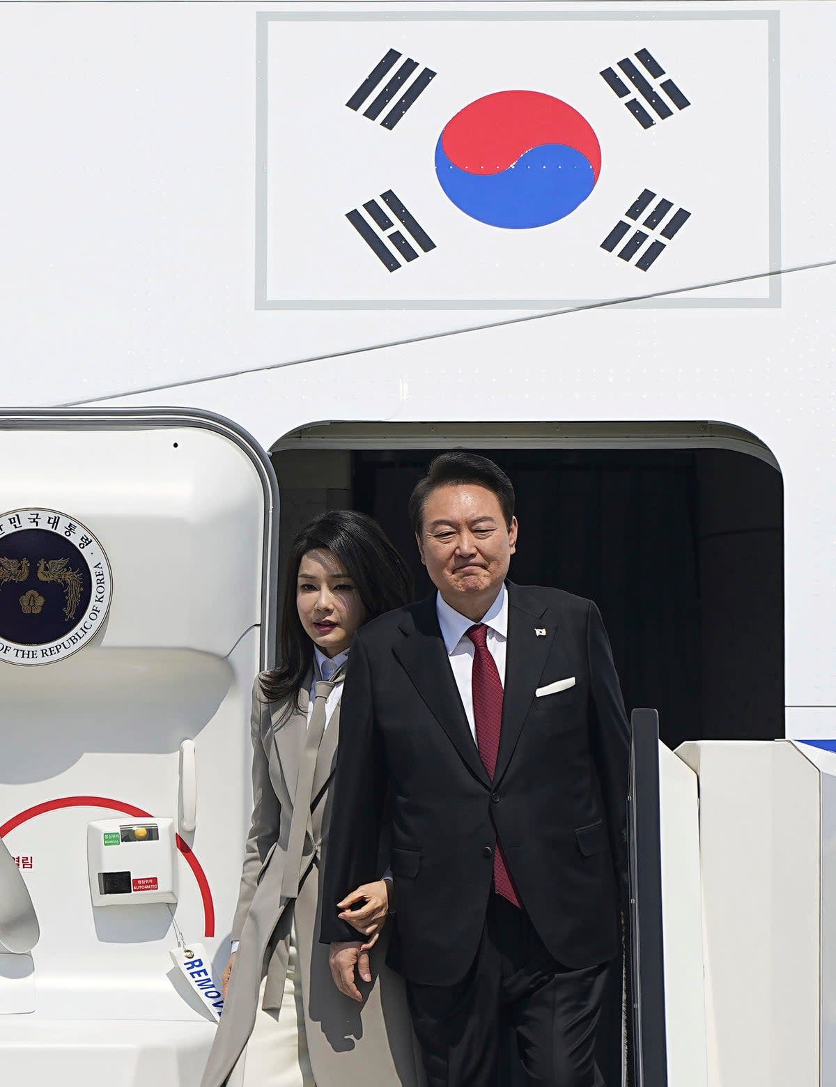 South Korean President Yoon Suk Yeol and his wife Kim Keon Hee arrive at Haneda International Airport in Tokyo, (AP)