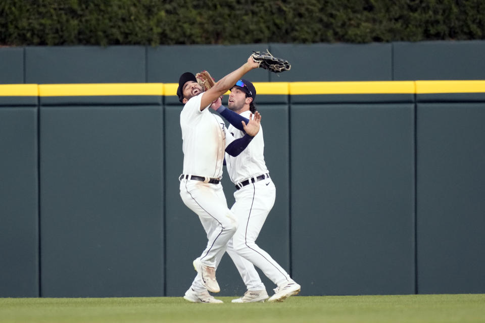 Detroit Tigers right fielder Matt Vierling, right, hits center fielder Riley Greene as Greene catches the fly out hit by Chicago White Sox's Clint Frazier, during the fifth inning of a baseball game, Friday, May 26, 2023, in Detroit. (AP Photo/Carlos Osorio)