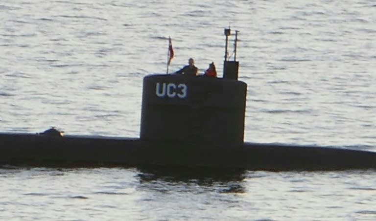 A person believed to be Swedish journalist Kim Wall stands next to a man in the conning tower of the submarine "UC3 Nautilus" made by Peter Madsen who was convicted of her murder