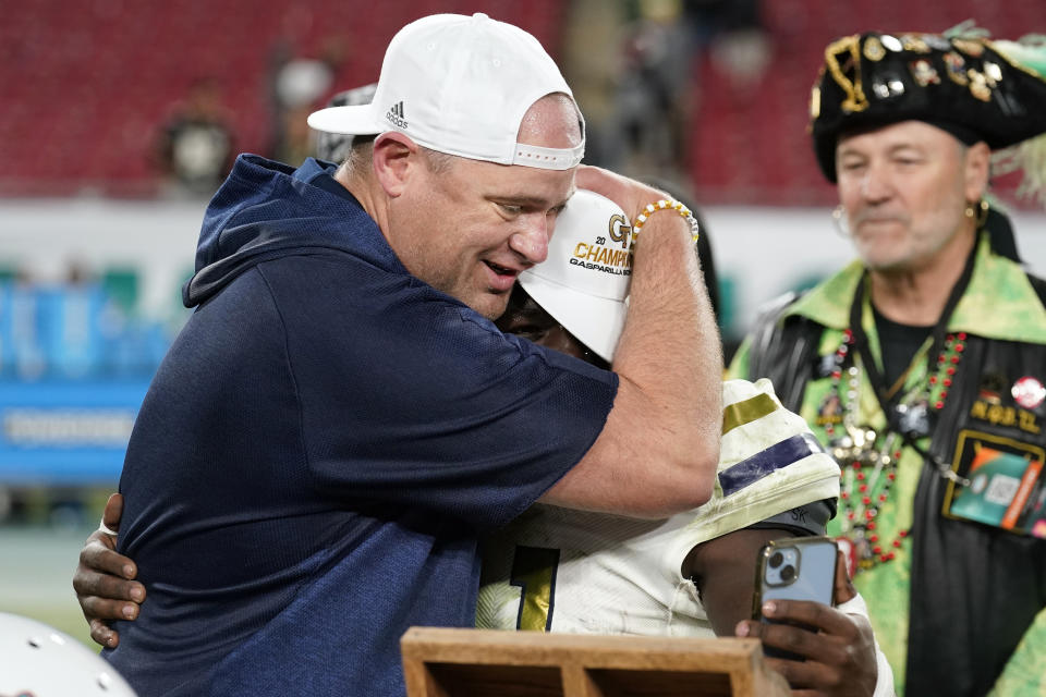 Georgia Tech head coach Brent Key hugs MVP running back Jamal Haynes (11) after the team defeated Central Florida in the Gasparilla Bowl NCAA college football game Friday, Dec. 22, 2023, in Tampa, Fla. (AP Photo/Chris O'Meara)