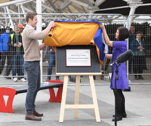 Natalie Grey, head of nursing at NHS Nightingale hospital (right) unveils a plaque on behalf of the Prince of Wales at the opening of the new medical facility. Stefan Rousseau/PA Wire