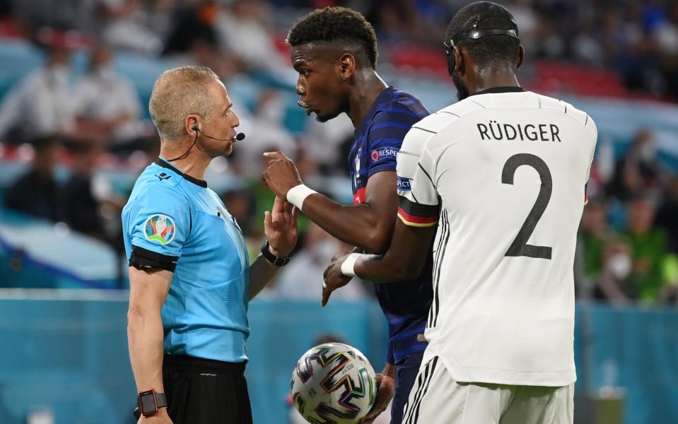 Pogba remonstrates with the assistant referee - REUTERS/Matthias Hangst