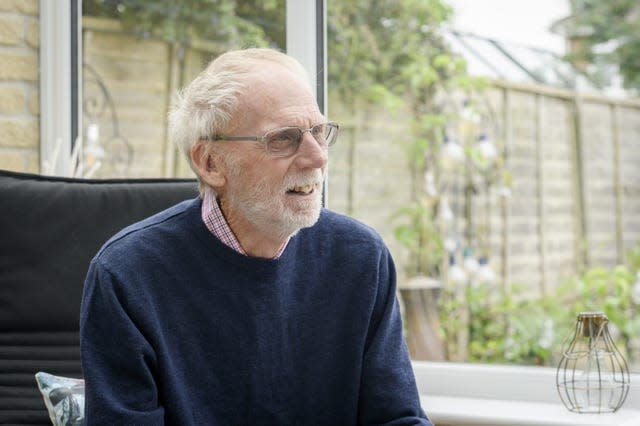 Mr Evans sat at a patio door