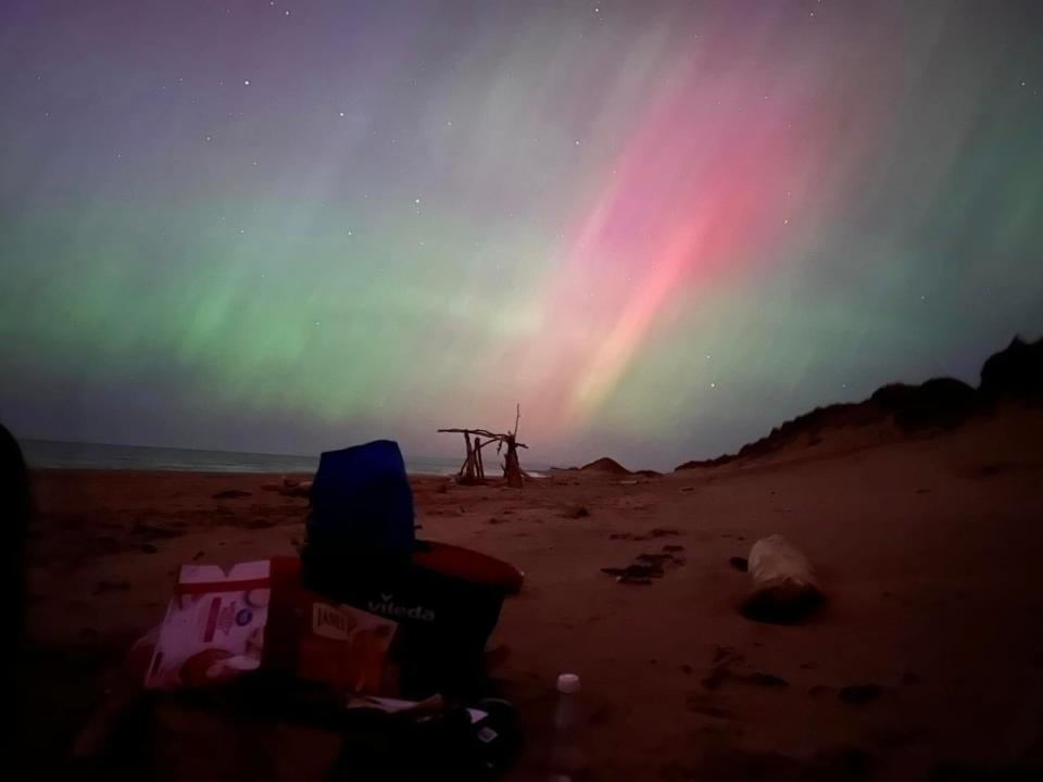 Blasts of pink and purple light rain down on Lakeside Beach around midnight.