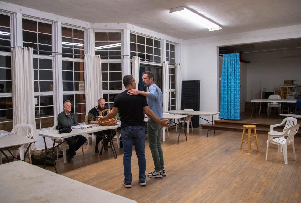 Actors Charles Herrera (left) and John Corr playing Max Brod and Franz Kafka respectively embrace while running through lines and blocking in a rehearsal of "Kafka's Joke" at Desert Art Center in Palm Springs, Calif., Thursday, March 2, 2023.