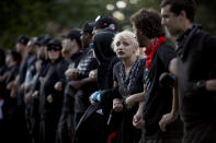 <p>Protesters with a group known as “Antifa”, or anti-fascists, link arms at an event on the campus of the University of Virginia organized by the group Students Act Against White Supremacy marking the one year anniversary of a deadly clash between white supremacists and counter protesters August 11, 2018 in Charlottesville, Virginia. Charlottesville has been declared in a state of emergency by Virginia Gov. Ralph Northam as the city braces for the one year anniversary of the deadly clash between white supremacist forces and counter protesters over the potential removal of Confederate statues of Robert E. Lee and Stonewall Jackson. A ‘Unite the Right’ rally featuring some of the same groups is planned for tomorrow in Washington, DC. (Photo: Win McNamee/Getty Images) </p>