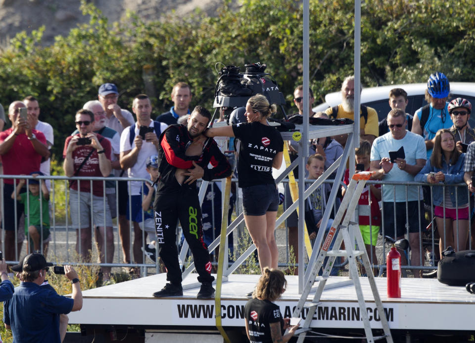 Franky Zapata, a 40-year-old inventor, during preparations for take-off in Sangatte, Northern France, at the start of his attempt to cross the channel from France to England Thursday July 25, 2019. Zapata is anchored to his flyboard, a small flying platform he invented, taking off from Sangatte, in France's Pas de Calais region, and flying to the Dover area in southeast England. (AP Photo/Michel Spingler)