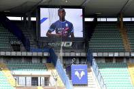 Parma's Yann Karamoh wears a jersey with writing reading "Keep racism out" as he is seen on a giant screen broadcasting a video of players from all 20 Serie A clubs and all sorts of backgrounds delivering a strong message of inclusion before a Serie A match between Verona and Atalanta at the Bentegodi stadium in Verona, Italy, Sunday, March 21, 2021. Serie A’s efforts to combat racism inside its stadiums was in shambles little more than a year ago when league CEO Luigi De Siervo decided to take matters into his own hands. (Paola Garbuio/LaPresse via AP)