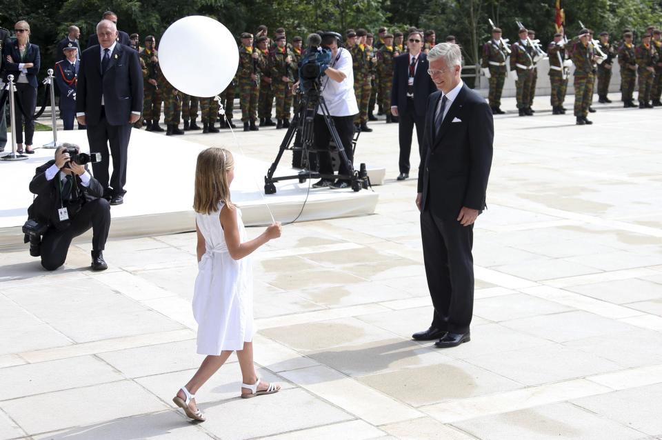 A girl holds a white balloon next to Belgium's King Philippe during a ceremony at the Cointe Inter-allied Memorial, commemorating the 100th anniversary of the outbreak of World War I (WWI) in Liege August 4, 2014. (REUTERS/Francois Lenoir)