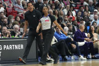 Miami Heat head coach Erik Spoelstra, left, argues a call with official Danielle Scott, right, during the first half of an NBA basketball game against the Washington Wizards, Sunday, March 10, 2024, in Miami. (AP Photo/Lynne Sladky)