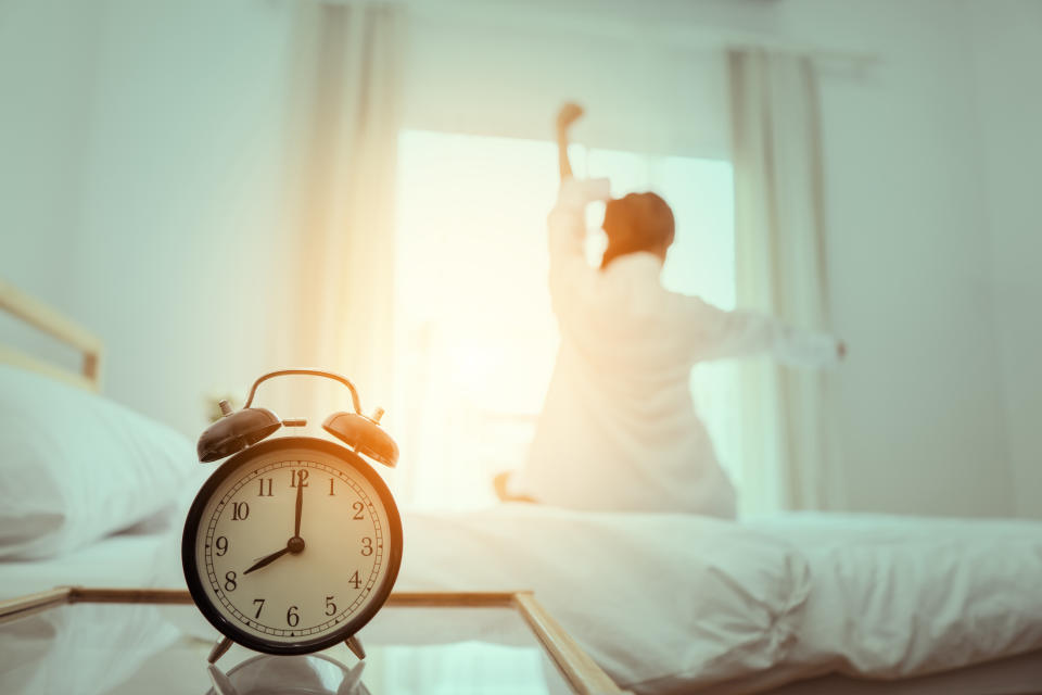 Person waking up to alarm clock. (Getty Images)