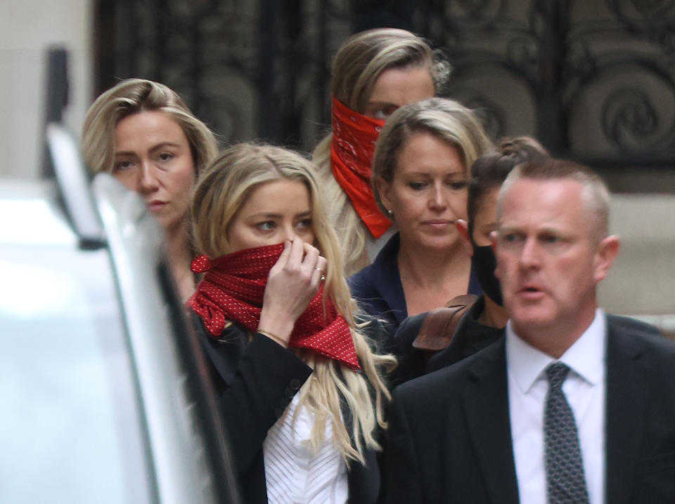 Actress Amber Heard (centre left) leaves the High Court in London during a hearing in Johnny Depp's libel case against the publishers of The Sun and its executive editor, Dan Wootton.