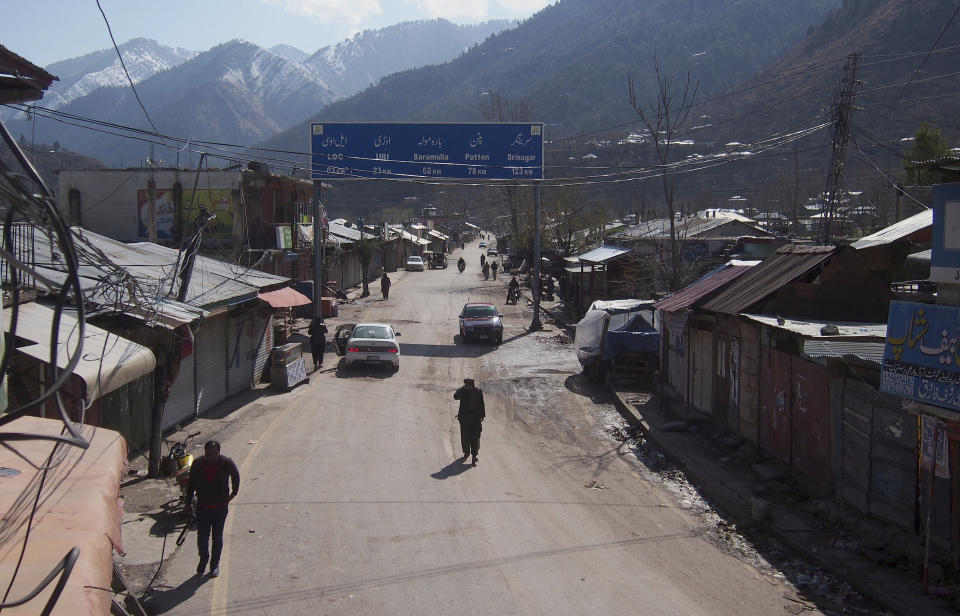 Pakistani Kashmiris walk through the closed main market, following the intense exchange of fire between Pakistan and India at the border town of Chakoti at the Line of Control in Pakistani Kashmir, Wednesday, Feb. 27, 2019. Pakistan's air force shot down two Indian warplanes after they crossed the boundary between the two nuclear-armed rivals in the disputed territory of Kashmir on Wednesday and captured one Indian pilot, a military spokesman said. (AP Photo/M.D. Mughal)